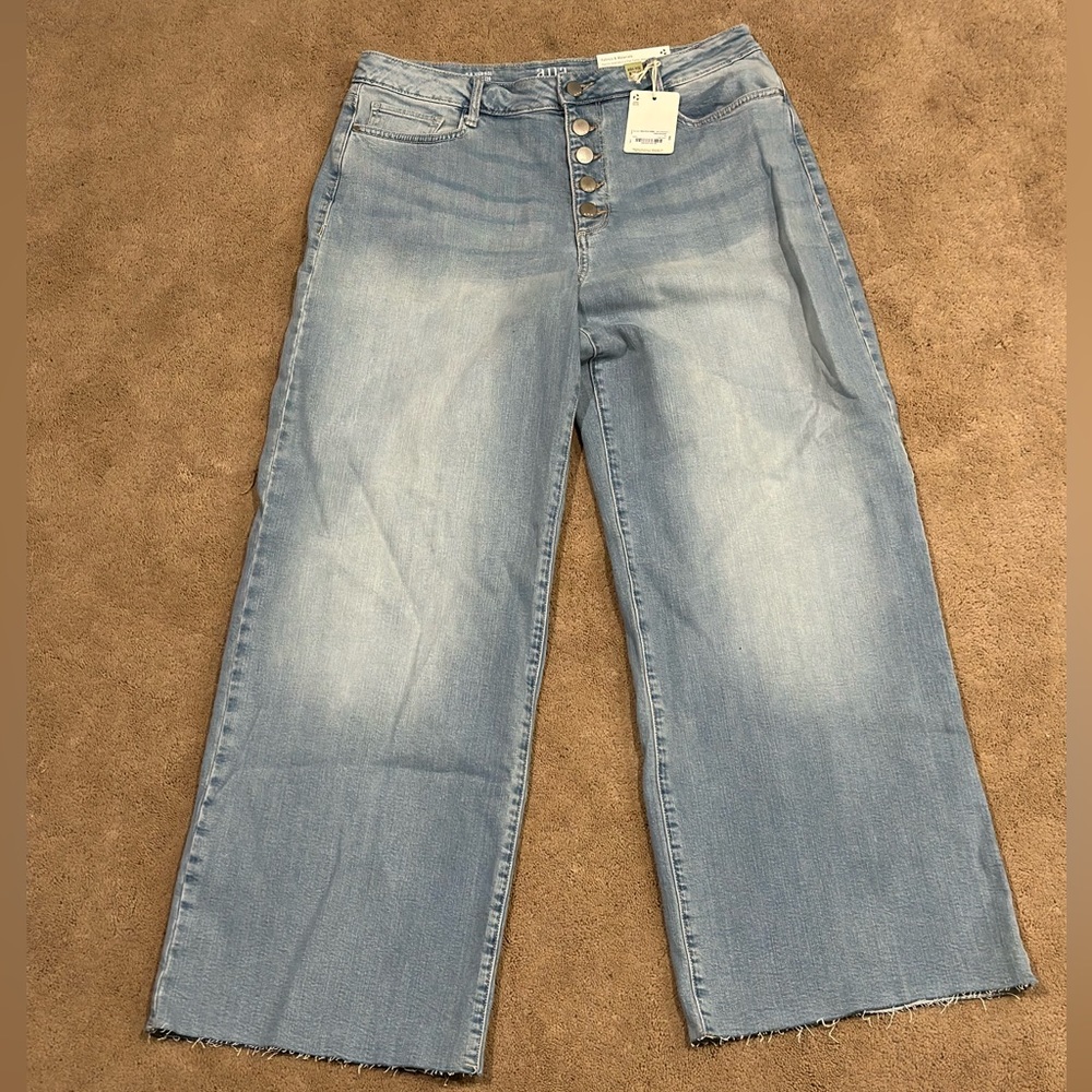 High waisted, wide leg, and button fly jeans